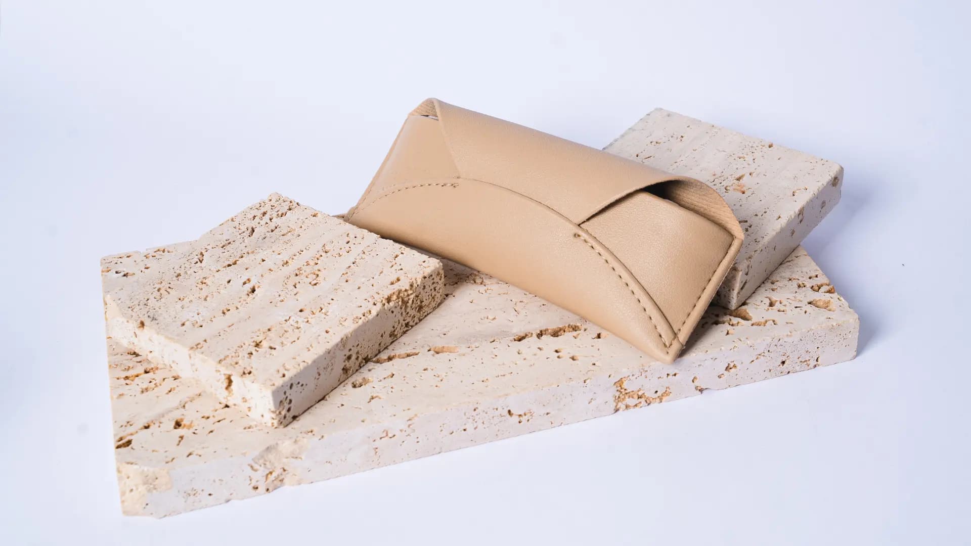 Rigid eyewear protection showcased with decorative mineral stones, representing durability and high-end design